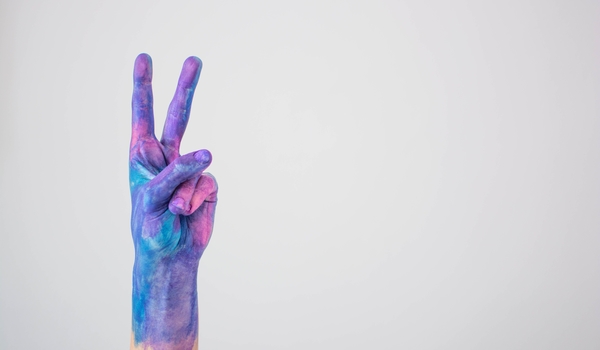 Blue Pink Colored Painted Hand Gesturing Peace Sign