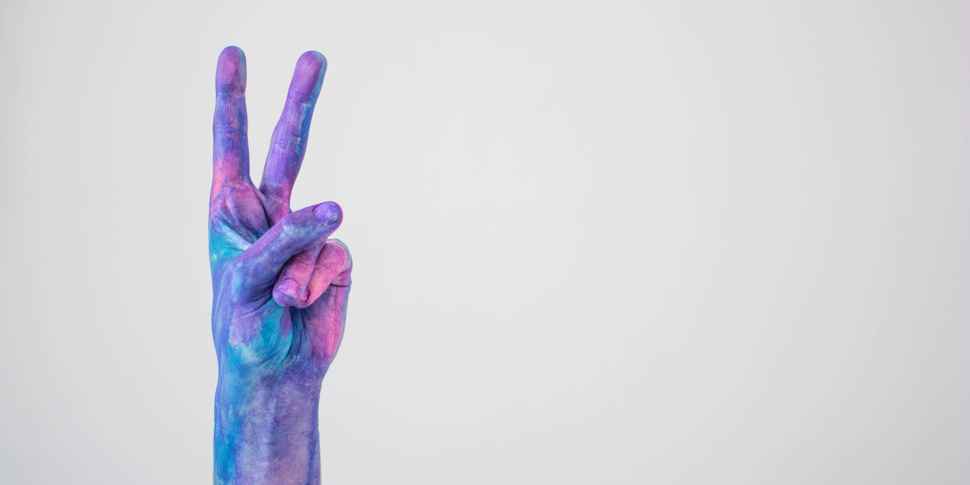 Blue Pink Colored Painted Hand Gesturing Peace Sign